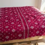 Hand stitched kantha 30 layer magenta floral design king size lifestyle on bed